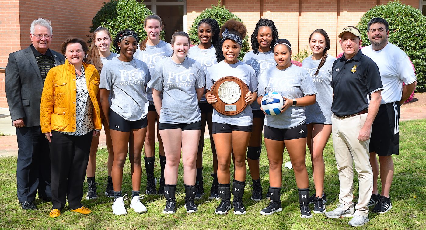 Volleyball team photo with Region 10 runner-up trophy