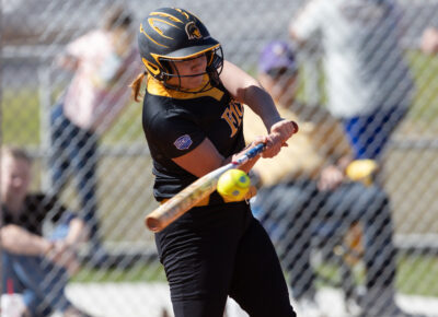 Softball player Chelsey Wilkes hits the ball