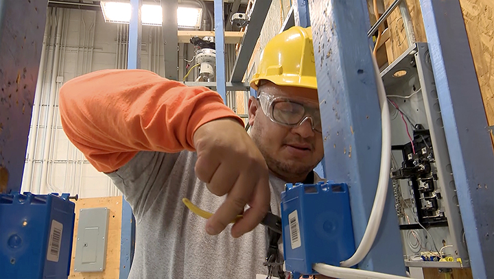 A man works on electrical wiring.