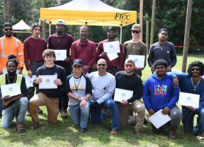 A group of people outside pose for a photo.