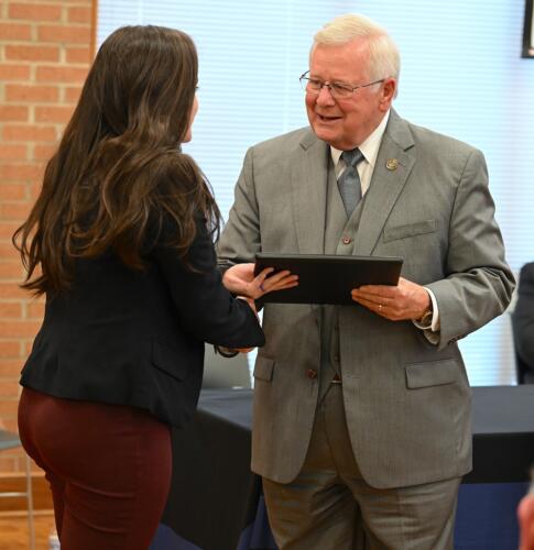 Rebecca Apostolos accepts her certificate and shakes hands with Dr. Keen.