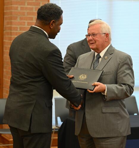 Cornell Causey accepts his certificate and shakes hands with Dr. Keen.