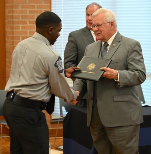 Stephen Covington accepts his certificate and shakes hands with Dr. Keen.