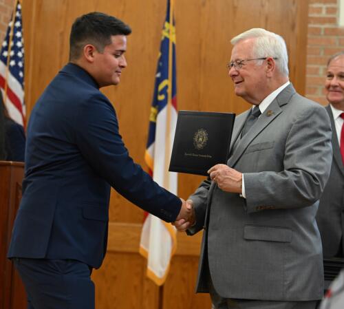 Abdiel Murguia-Fuentes accepts his certificate and shakes hands with Dr. Keen.