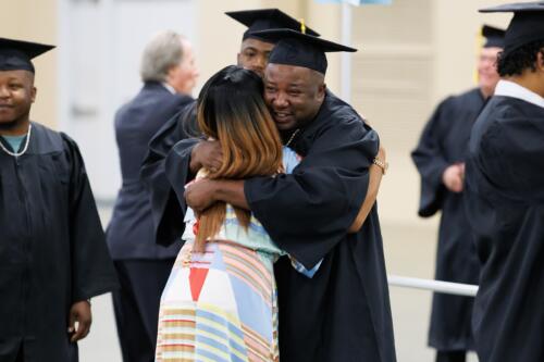 Tammy Thurman hugs a graduate.