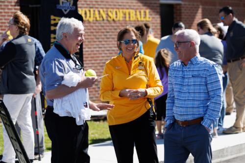 Mandy McMillan talks with VIPs, including Joe Riddle, outside of the Softball Fieldhouse at JP Riddle Stadium.