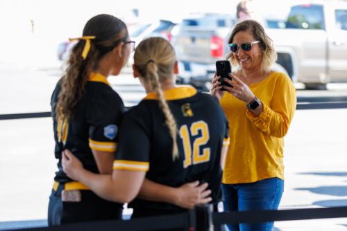 Softball players pose for a photo before the game.