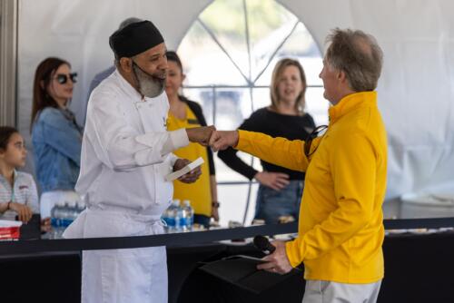 Culinary Arts student Leonard Cobb and Dr. Mark Sorrells share a fist bump.