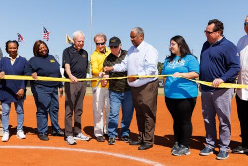 Mark Sorrells, Larry Keen and Glenn Adams, surrounded by FTCC stakeholders, cut the ribbon.