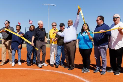 Glenn Adams holds up the end of the ribbon after it was cut.