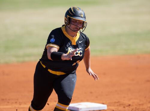 A FTCC softball player rounds second base.