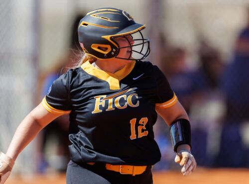 A FTCC softball player runs to first base.