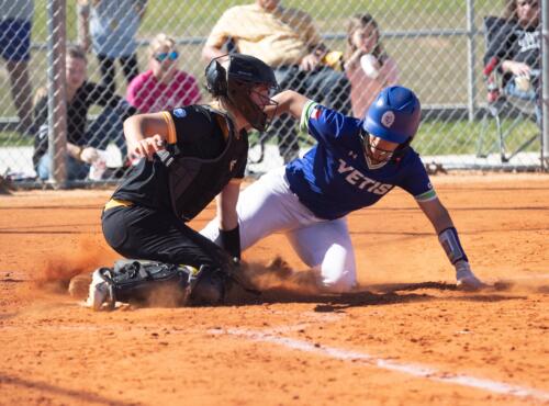 The FTCC softball catcher blocks home plate from a sliding Cleveland Community College baserunner.