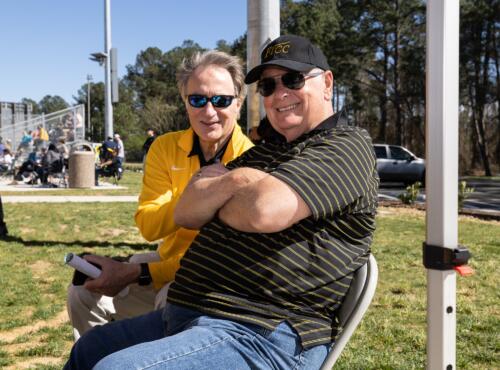 Mark Sorrells and Larry Keen pose for a picture while watching the softball game.