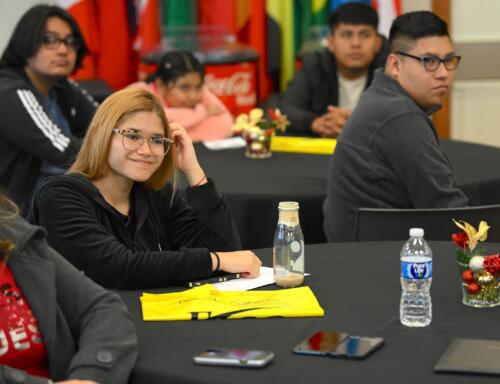 Family members of graduates sit at the graduation for the Spanish Language Electrical Program.